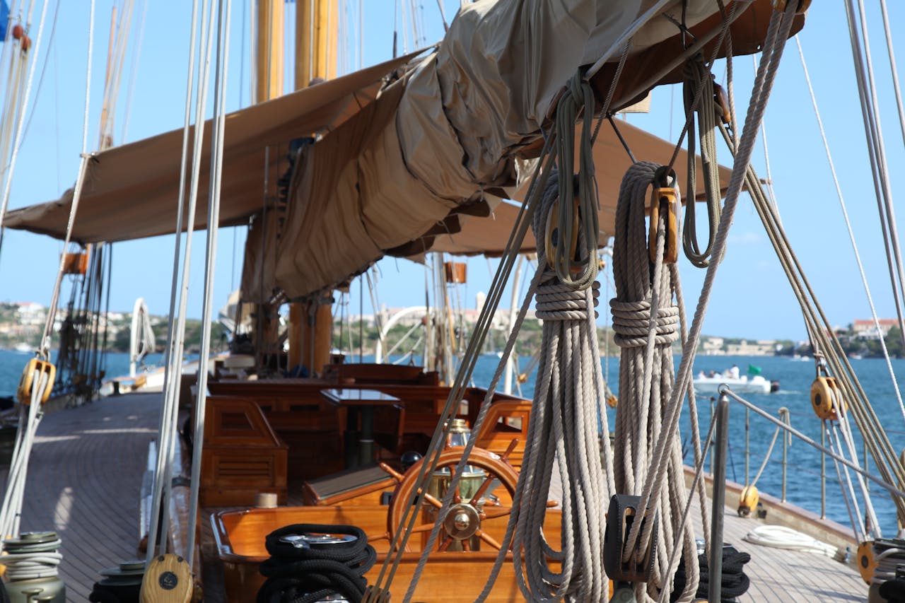 A classic sailing yacht docked at Ciudadela de Menorca, showcasing nautical design and Mediterranean scenery.